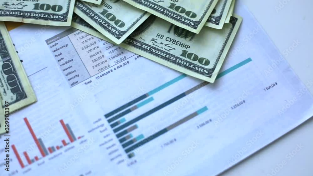 money and charts on the table in the office money and charts on the table in the office