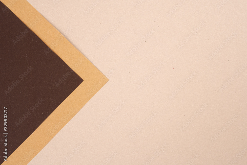 Background from recycled textured paper forming abstract triangular shades of dark brown Background from recycled textured paper forming abstract triangular shades of dark brown