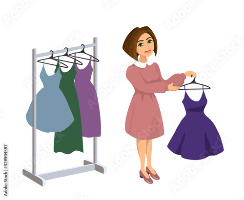 Beautiful girl seller consultant offers to buy a beautiful dress in a clothing store. Girl costume designer or stylist.