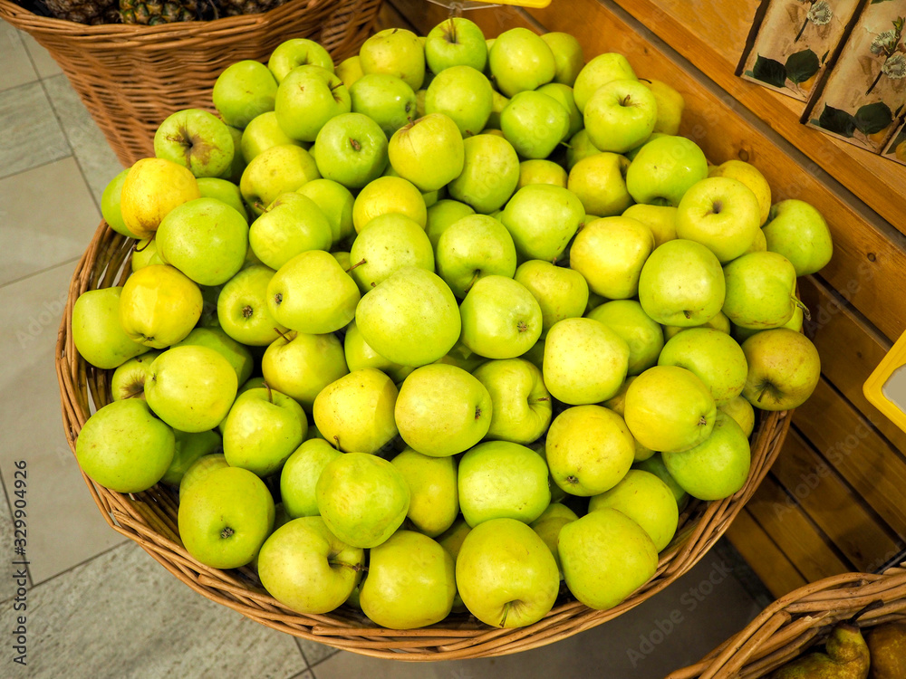 baskets with sweet yellow apples in the mall