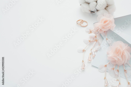 Wedding background, decorated with decorations for the bride's dress, white feather, cotton flower, pearl hairpins, around the text space, all in pastel colors. Concept preparation for the wedding