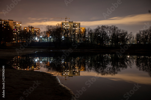 Fototapeta Naklejka Na Ścianę i Meble -  The night landscape of the building and reflection in the lake