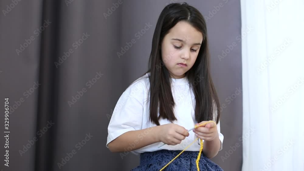 little girl crochet and yellow thread at home little girl crochet and yellow thread at home