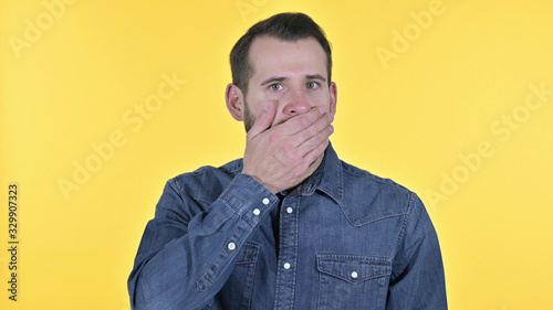 Portrait of Wondering Young Man in Shock, Yellow Background
