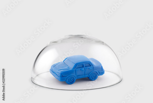 Fototapeta Blue toy car protected under a glass dome