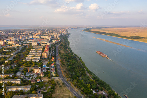 Aerial view of Galati City, Romania. Danube River near city with sunset warm light