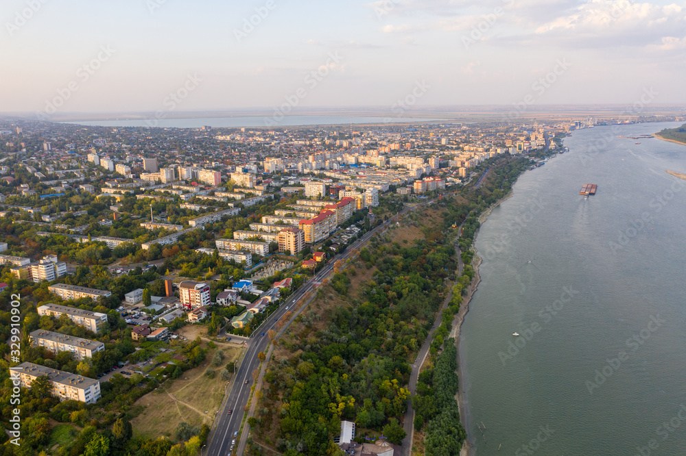 Fototapeta premium Aerial view of Galati City, Romania. Danube River near city with sunset warm light