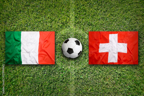 Italy vs. Switzerland flags on soccer field