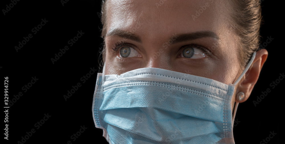 Mouth mask. Beautiful caucasian infected girl in medical mask on black background . Coronavirus covid-19 concept. Pandemic global spread Mouth mask. Beautiful caucasian infected girl in medical mask on black background . Coronavirus covid-19 concept. Pandemic global spread
