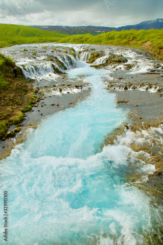 Tiny waterfalls performed a beautiful blue stream.