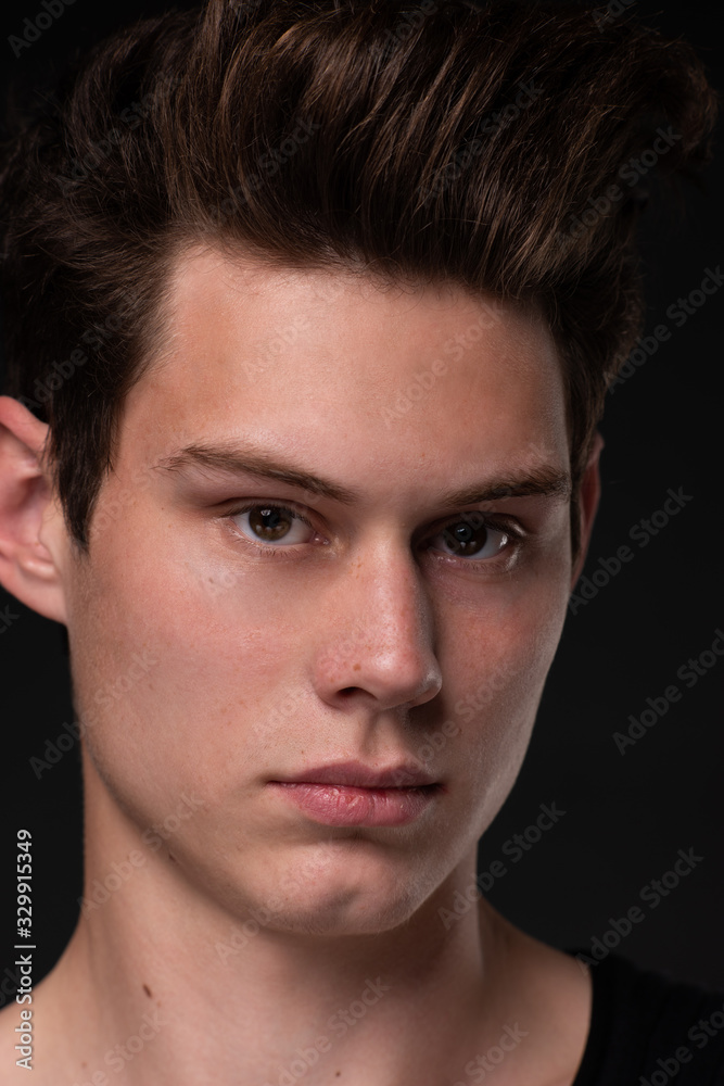 Naklejka premium Portrait of a young handsome dark haired man with a fan