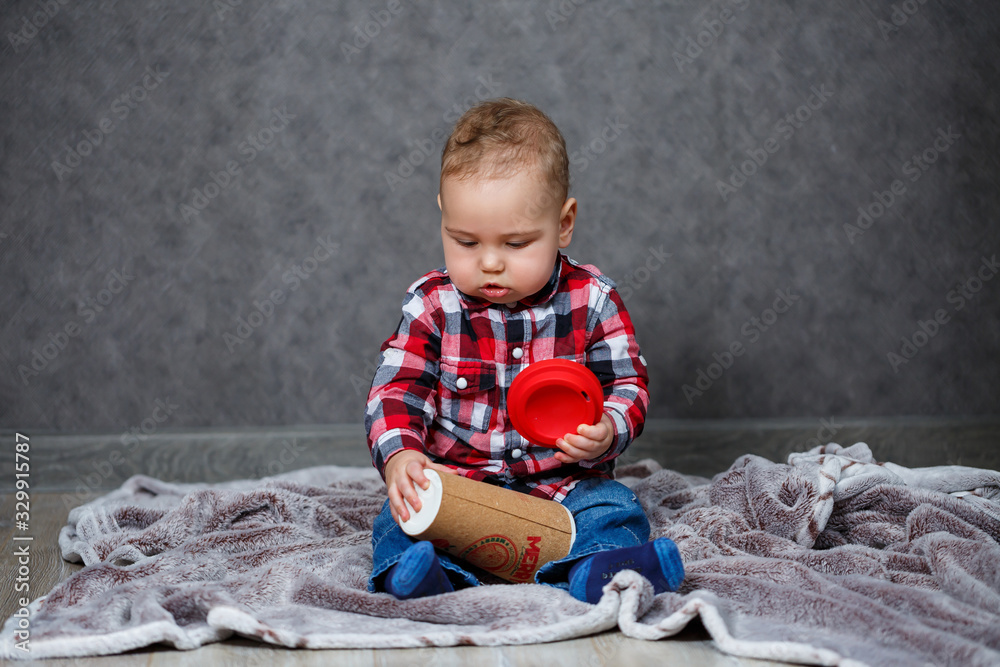 Fototapeta premium little boy ten months old in a shirt and jeans
