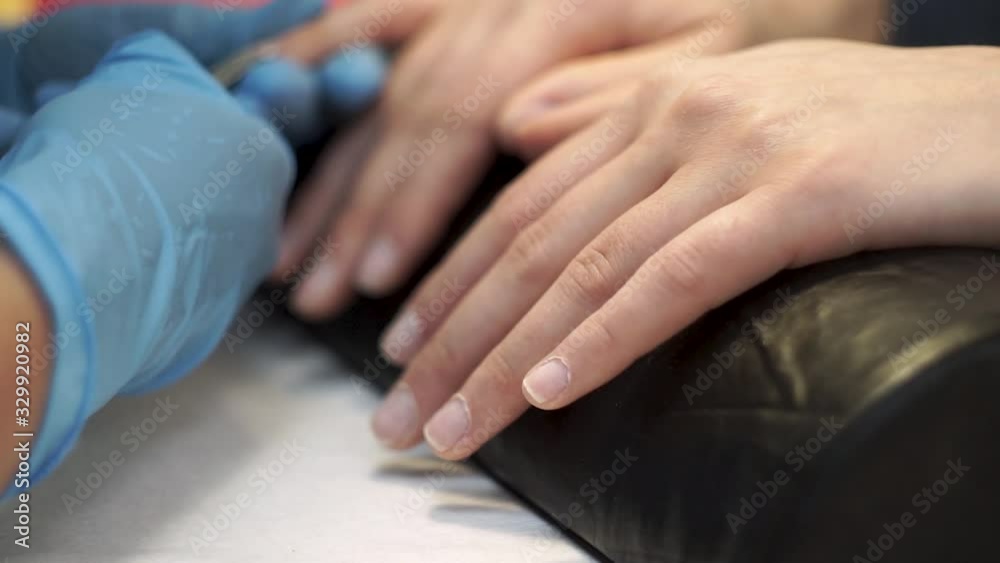 Manicurist bites off cuticle nippers. Manicurist bites off cuticle nippers.
