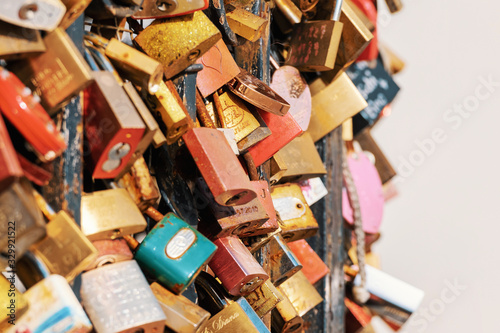 Closeup of love padlocks around fenced well on the Kahlenberg hill in Vienna