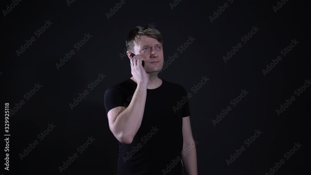 The man on the phone Hello on a black background The man on the phone Hello on a black background