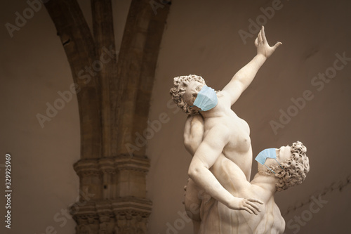 The Kidnapping of the Sabine Women Statue by Giambologna, in the Loggia dei Lanzi in Florence Italy With Face Masks - Coronavirus Scare