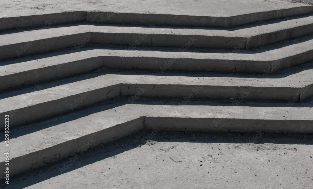concrete curvilinear steps without a ramp. The falling shadow from a product from concrete in the form of a zigzag concrete curvilinear steps without a ramp. The falling shadow from a product from concrete in the form of a zigzag