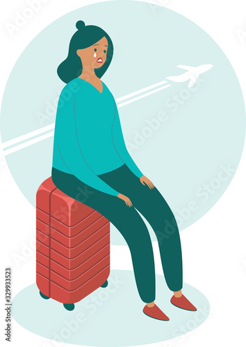 Upset woman sitting on her suitcase 