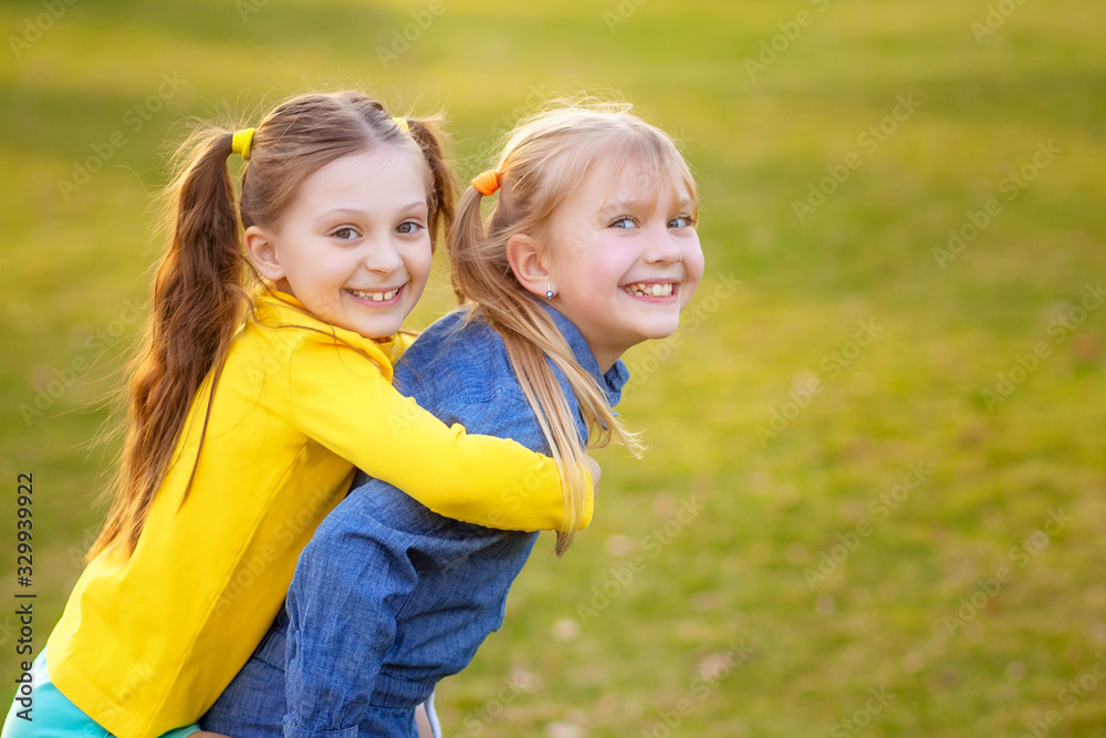 Happy children play and relax in the summer park. Happy children play and relax in the summer park.