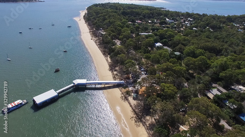 aerial view of a ferry arriving at coochiemudlo island in morton bay photo