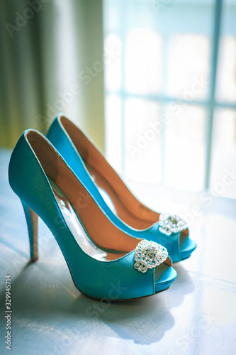 Teal color high heeled pumps on a table for the bride to be