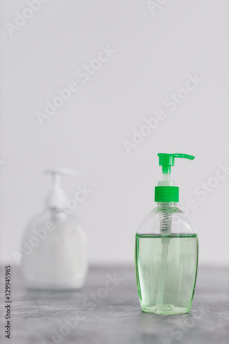 hygiene against viruses and bacteria, hand sanitizer and liquid soap bottle on marble bathroom