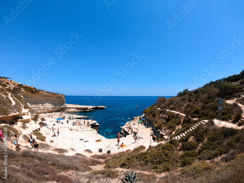 People enjoying the natural pool of Malta.