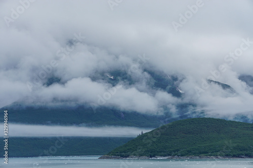 Yakutat Bay, Alaska, USA: Clouds descending on a mountainside at the edge of Yakutat Bay.