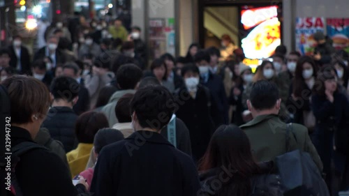 Wallpaper Mural TOKYO, JAPAN - MARCH 2020 : Crowd of people at the street near Shinjuku station in rush hour. Commuters and tourists wearing surgical mask to protect from Coronavirus(COVID-19) or cold. Slow motion. Torontodigital.ca