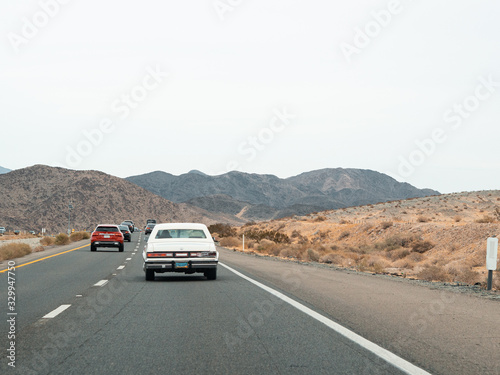Mojave, United States - December 02, 2019: Car traffic by road in the Mojave Desert. © DavidRojasS