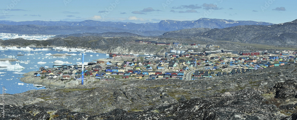 View from a nearby hill, overlooking the town of Illulisat, West Greenland .