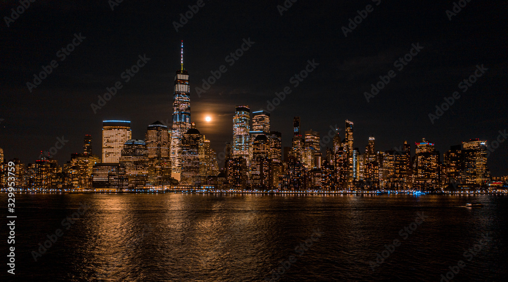 Aerial view of NewYork City and downtown skyline from Hudson River at night