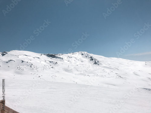 Beautiful view of snowy mountains, beautiful European winter mountains in Sierra Nevada, slope for cross-country skiers in the landscape.