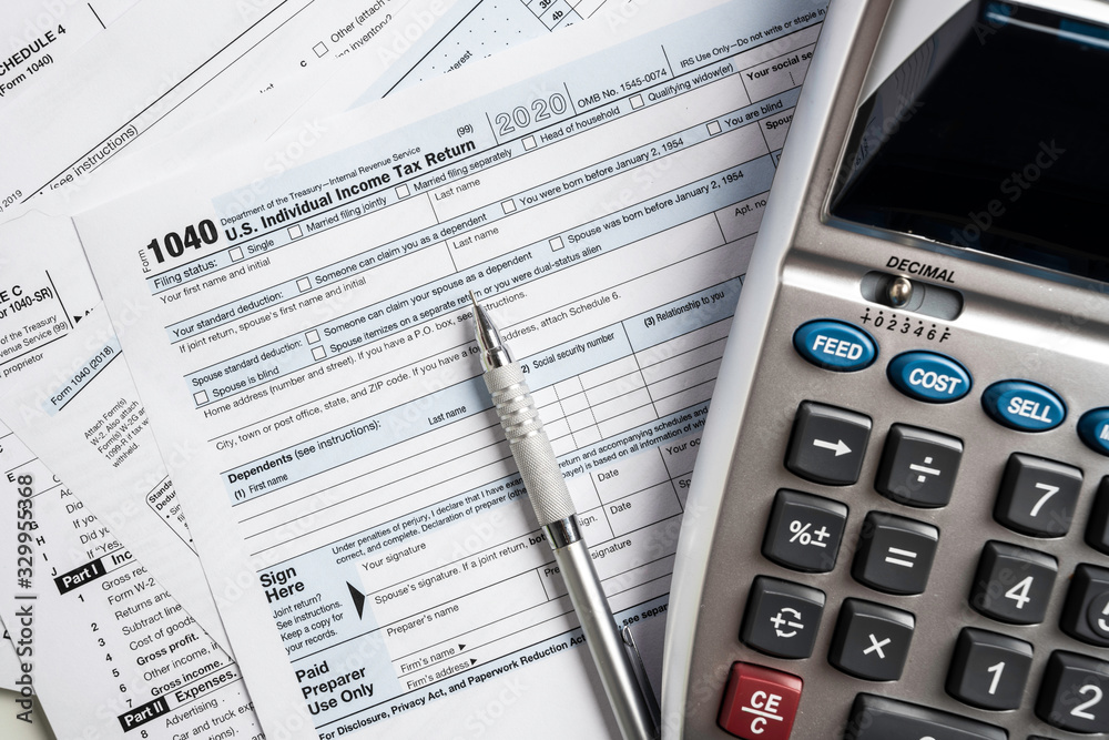 United States tax forms with calculator Stock Photo | Adobe Stock