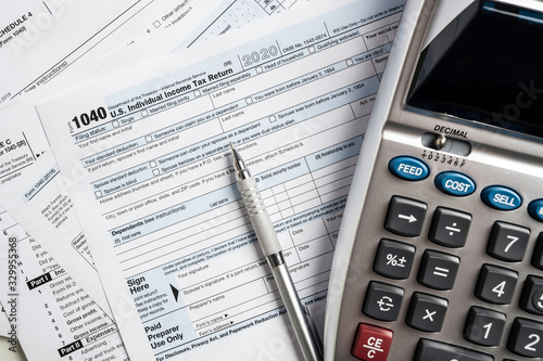 Фотография United States tax forms with calculator