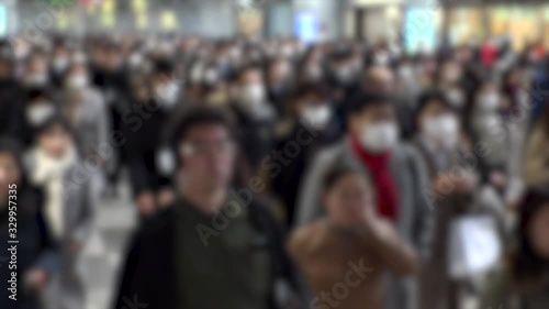 Wallpaper Mural TOKYO, JAPAN - MARCH 2020 : Crowd of people walking at Shinagawa station in morning rush hour. Commuters going to work. People wearing mask to protect from Coronavirus(COVID-19). Blurred slow motion. Torontodigital.ca