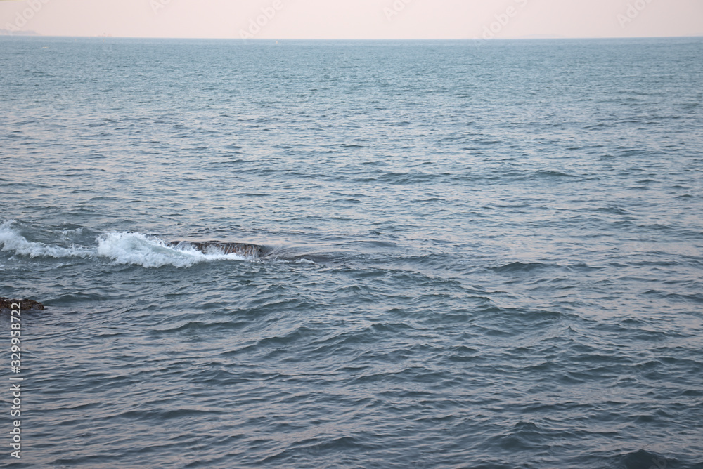 Waves breaking over a rocky outcrop creating a whirlpool and waterfall effect Waves breaking over a rocky outcrop creating a whirlpool and waterfall effect