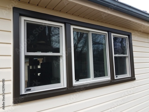 house with new windows installed and dark trim