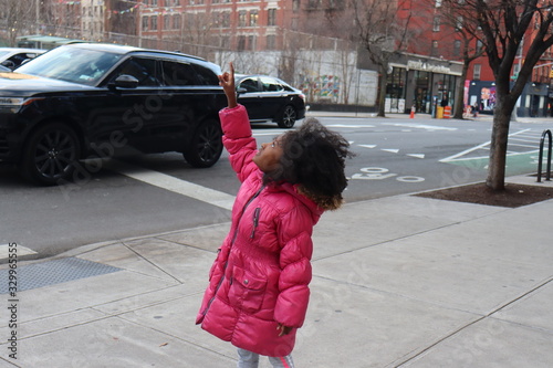 Photography Little Girl on city sidewalk pointing upwards