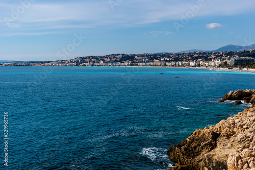 The panoramic view of the Mediterranean Sea with the landscape of city of Nice on the horizon and coastline cliffs on a sunny day (Provence Côte d'Azur, France)