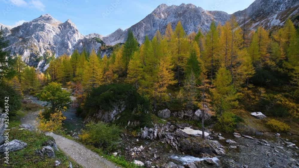 Autumn alpine stream view from mountain hiking path to Tappenkarsee, Kleinarl, Land Salzburg, Austria. Picturesque hiking, seasonal, and nature beauty concept scene. Autumn alpine stream view from mountain hiking path to Tappenkarsee, Kleinarl, Land Salzburg, Austria. Picturesque hiking, seasonal, and nature beauty concept scene.