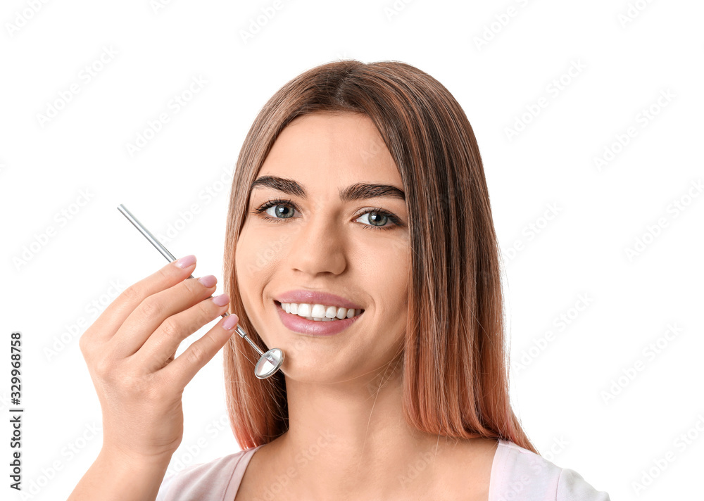 Beautiful young woman with dental mirror on white background Beautiful young woman with dental mirror on white background
