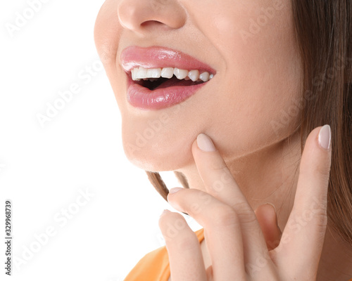 Young woman with beautiful smile on white background  closeup