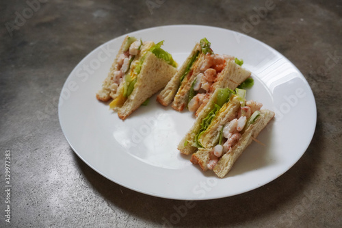 Delicious crayfish/king prawn with cheese and omelette sandwich on malted bread and mayonnaise on fresh lettuce.
