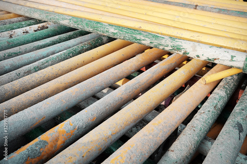 Colorful metal support pipes stack. Metal tubes used in building industry.