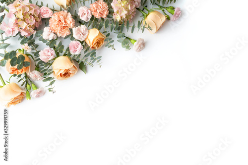 A flower arrangement of peach roses, pink hydrangeas, purple carnations and eucalyptus leaves. Celebrate your wedding, birthday, anniversary, baby shower or mothers day with this stylish flora display