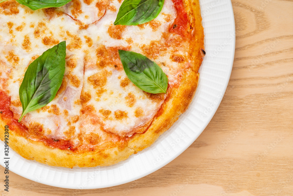 italian pizza on the wooden background, top view