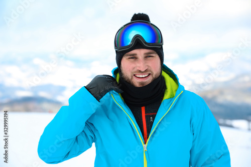 Young man at mountain resort. Winter vacation