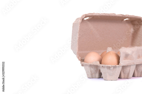 Brown paper egg box and egg isolated on white background.