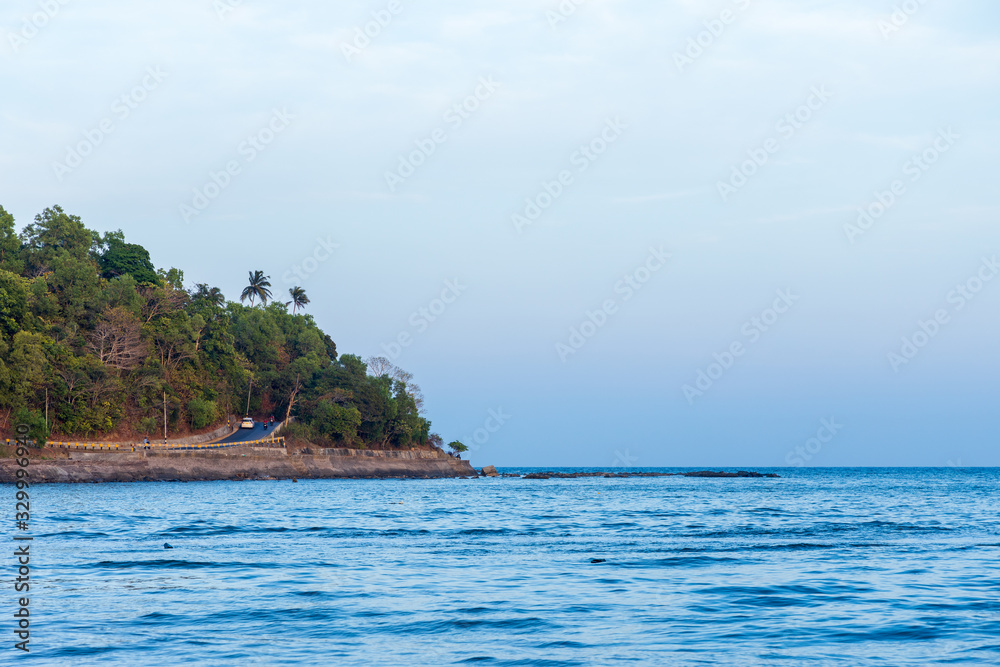 The road leading to Corbyns Cove Beach in Port Blair in the Andaman and Nicobar Islands of India during sunset. The road leading to Corbyns Cove Beach in Port Blair in the Andaman and Nicobar Islands of India during sunset.
